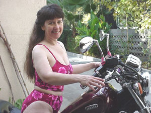 Dangerous Curves loves to ride her Virago and can even pick the damn thing 
off the ground; here she is
 just moments before she has to do that.